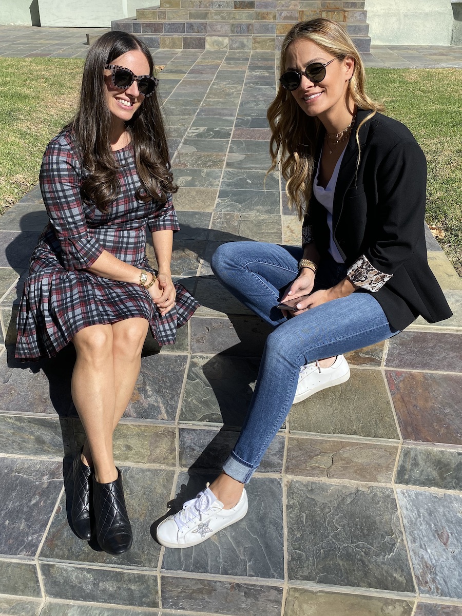 Two women sitting on steps wearing Stylevate clothing